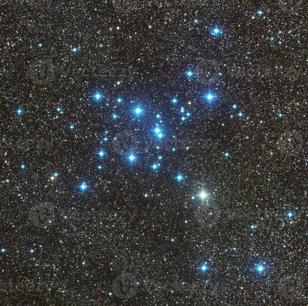 M7 Ptolemy star cluster imaged through Telescope Live's remote robotic telescopes, starry and bright environment with blue stars above photo