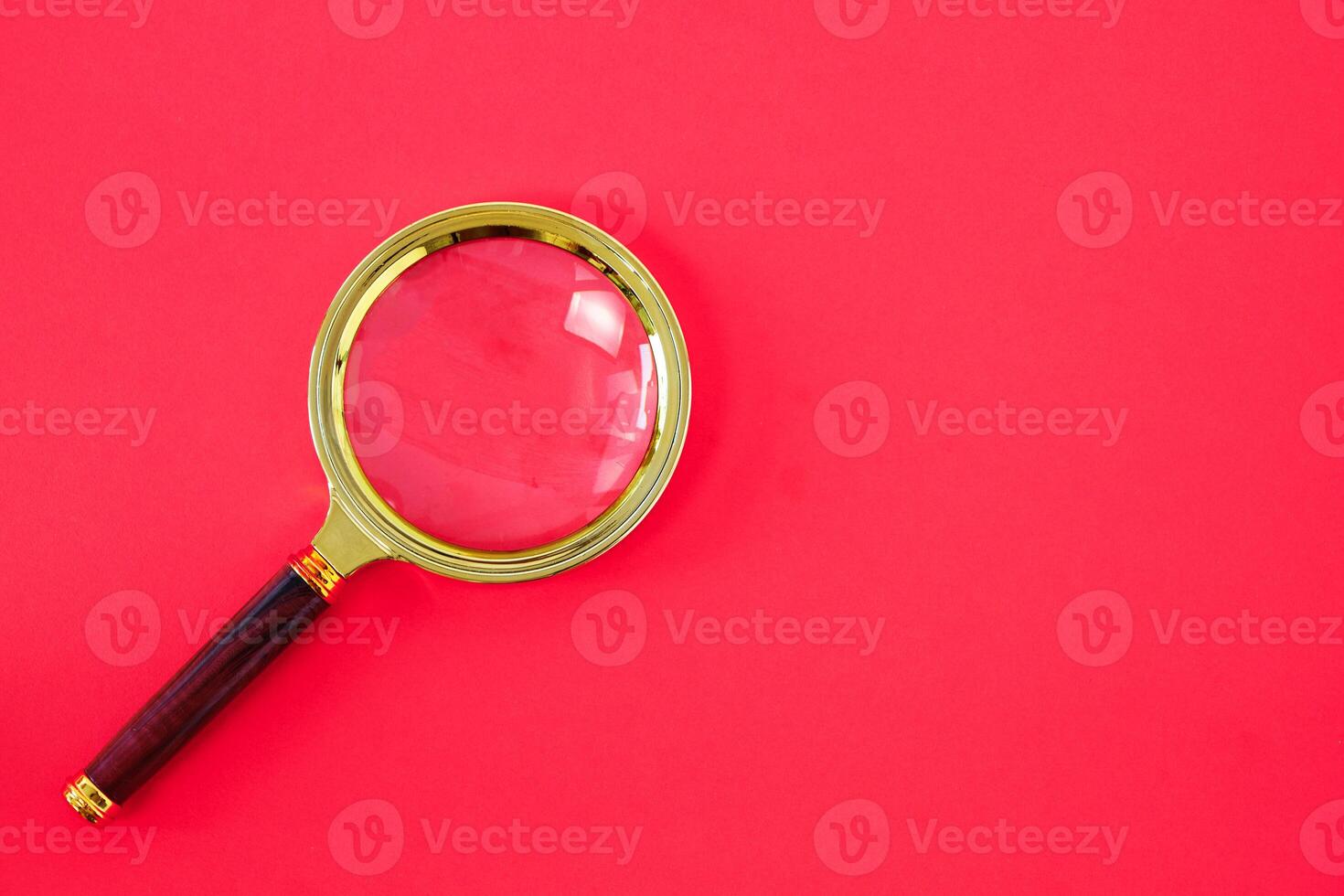Magnifying glass on a bright red background. 7976512 Stock Photo at