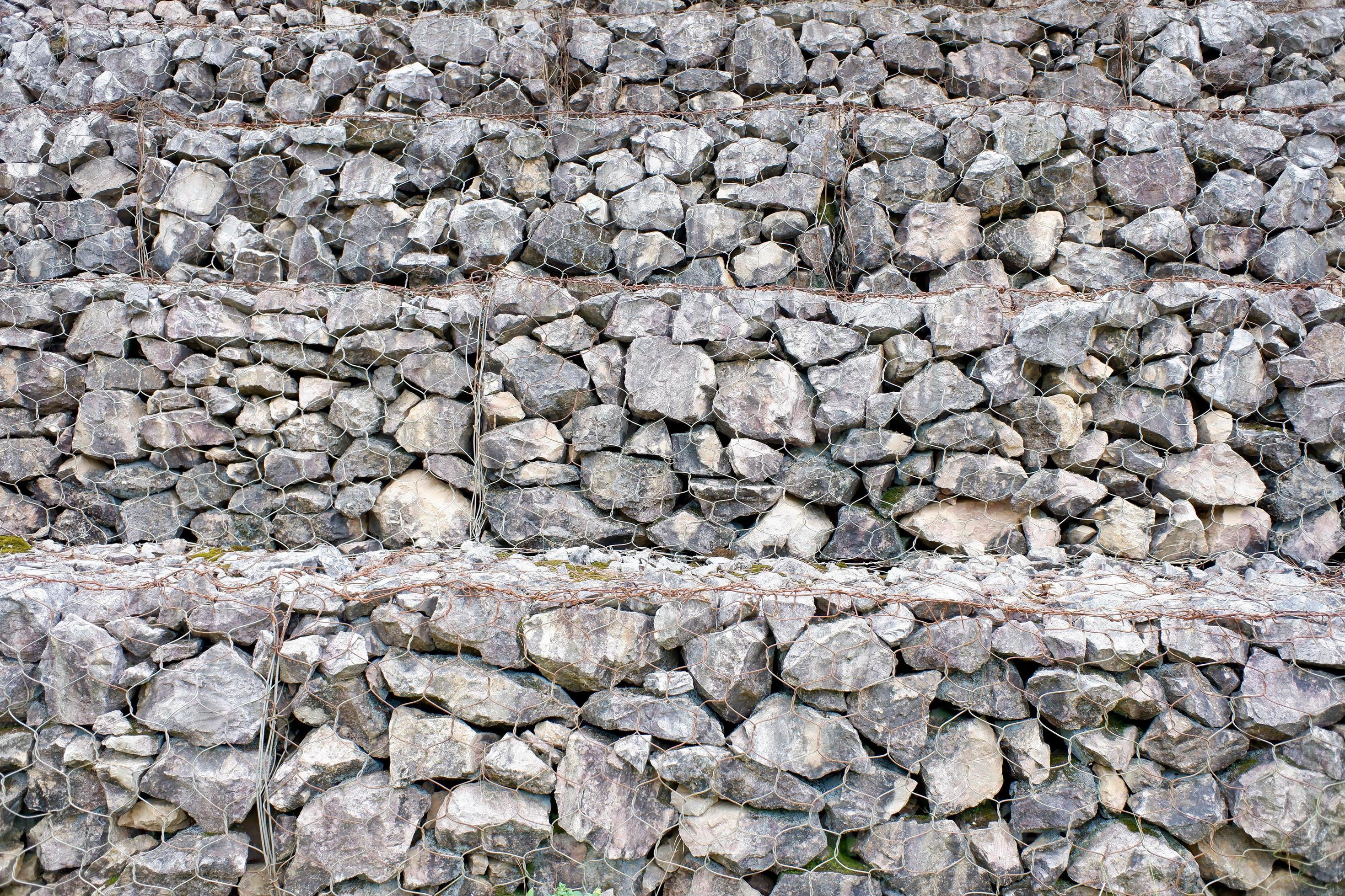 Stonewall texture. gray stones and rocks of different shapes on, the