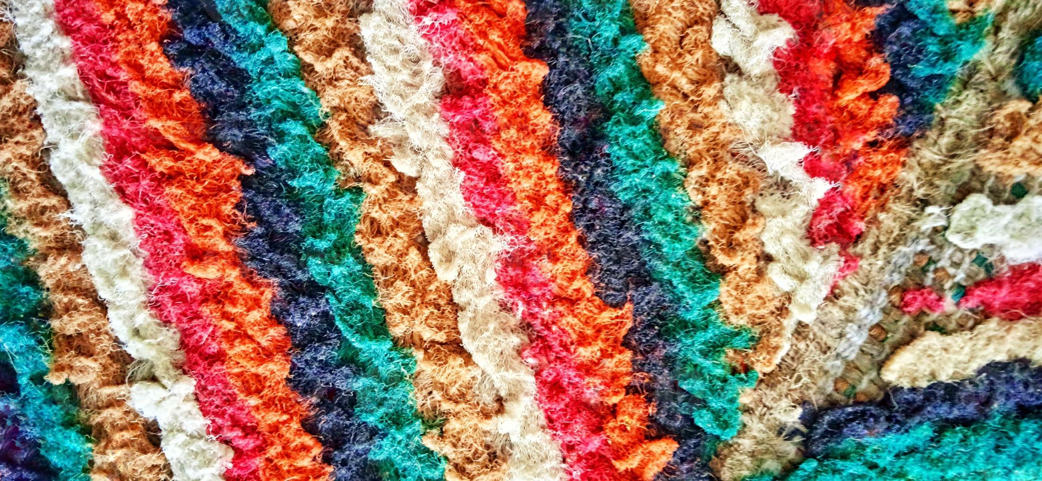 Variegated multicolor straight woven carpet texture. Fuzzy thin grunge vertical line textile material. Curly carpet rug fabric effect. photo