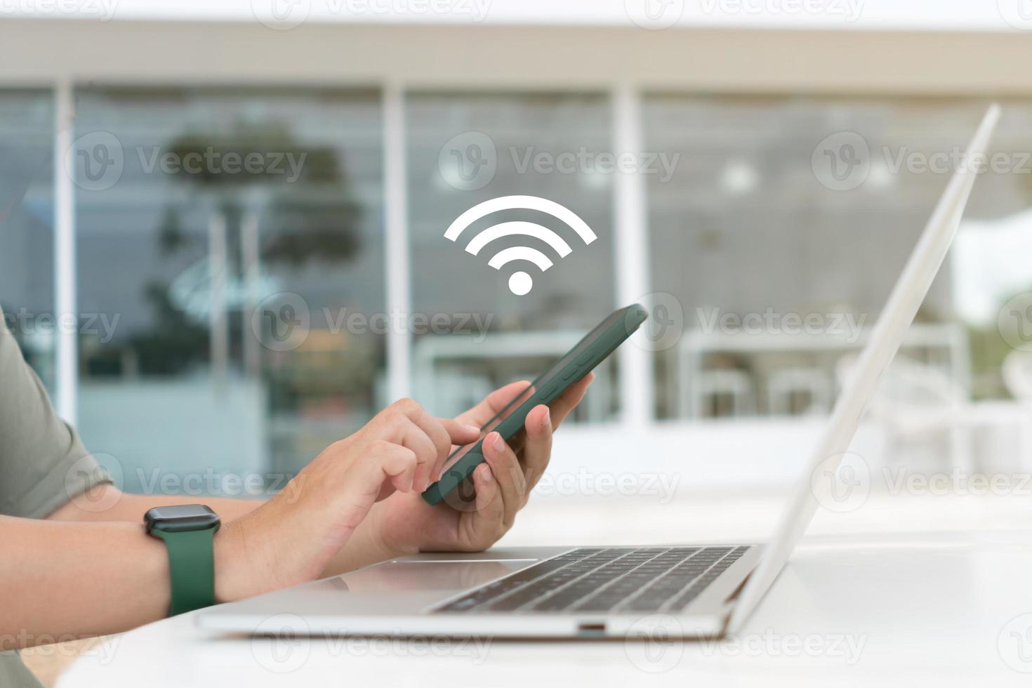 In a cafe shop background, a woman uses a laptop with a wifi icon. Social networking concept. photo