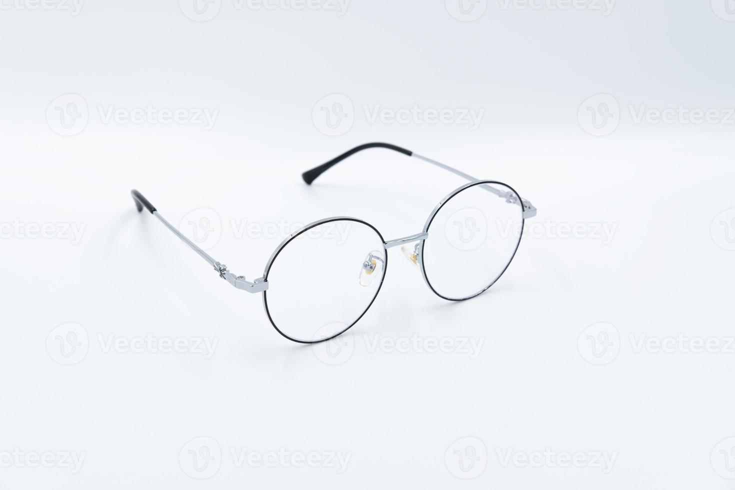 Selective focus round eyeglasses with silver rim. Front right view. Isolated white background. photo