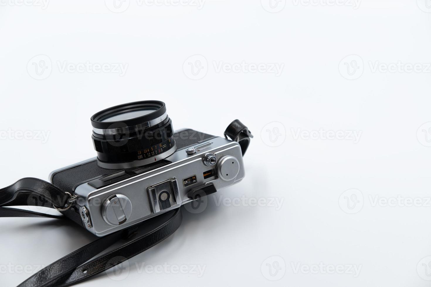 Isolated white background Beautiful vintage analog rangefinder film camera. 70's Decade film camera. Bottom left of frame image copy space. photo
