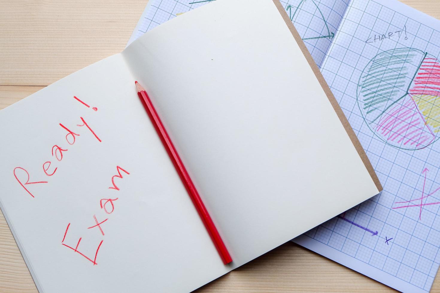 Success concept about education or examination.There are pencils, color, many charts on graph paper,pages of notebook with Ready Exam word on wooden background. photo