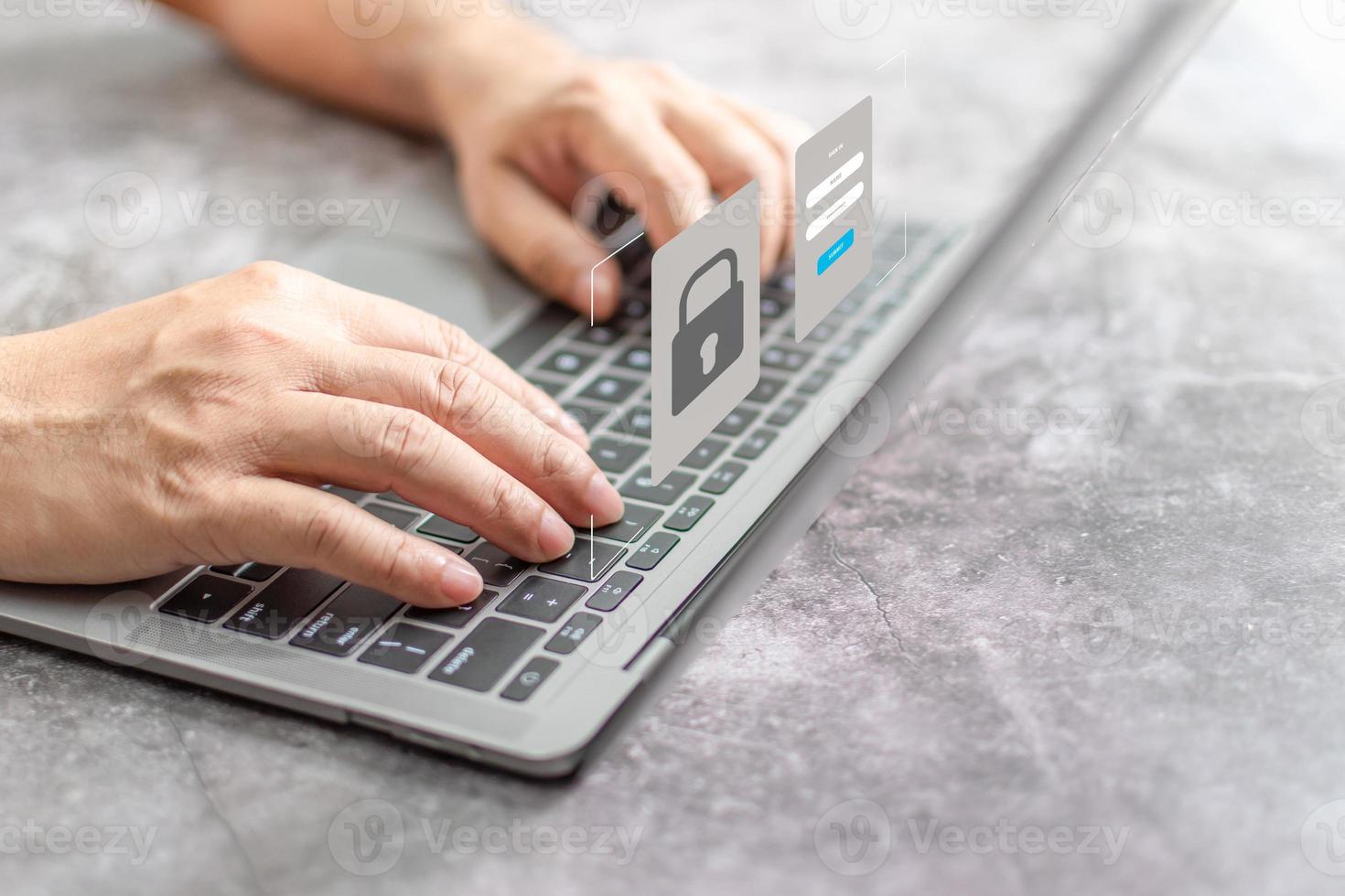 Man typing on keyboard to use computer network. Laptop screen showing login for security system. Concept work at home with computers and Internet. Notebook computer on table. close up, blur background photo