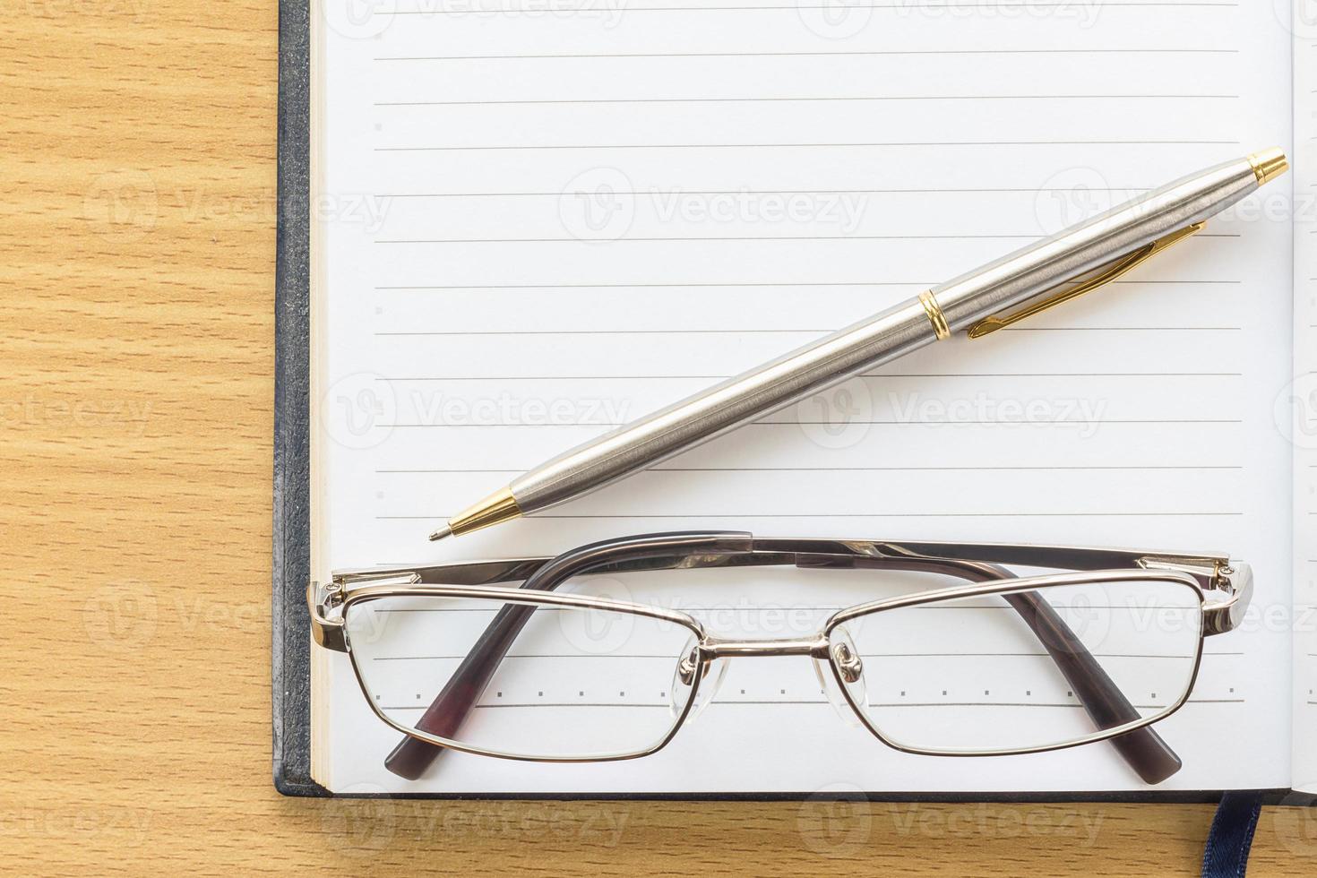 Notebook open blank page and Eyeglasses photo