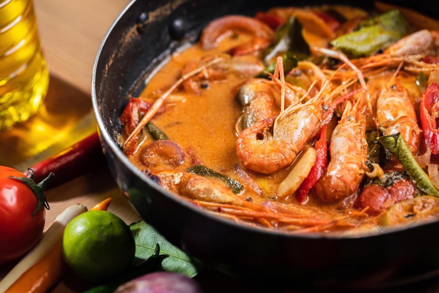 Tom Yum Goong or Tom Yum Kung, Thai hot and sour shrimp soup in pan. Popular Thai food in Thai cuisine restaurant. Shrimp and Spices with lemongrass, lemon, galangal, chili in coconut milk. Closeup photo