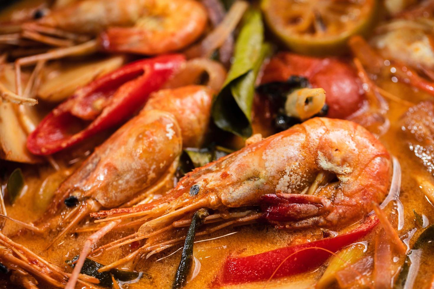 Tom Yum Goong vs Tom Yum Kung, Thai hot and sour shrimp soup. Popular Thai food in Thai cuisine restaurant. Shrimp and Spices with lemongrass, lemon, galangal and chili in coconut milk. Top view. photo