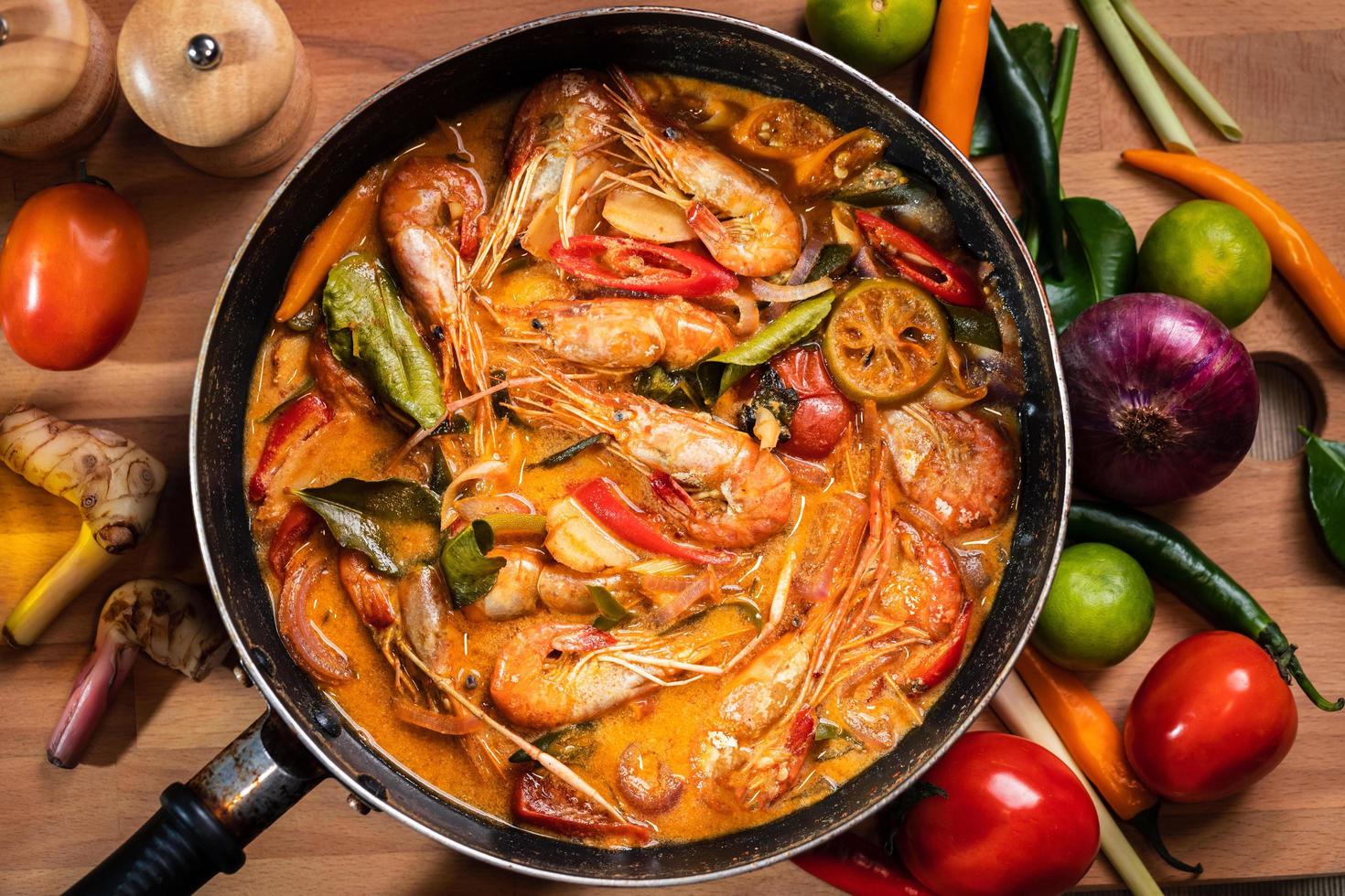 Tom Yum Goong or Tom Yum Kung, Thai hot and sour shrimp soup in pan. Popular Thai food in Thai cuisine restaurant. Shrimp and Spices with lemongrass, lemon, galangal, chili in coconut milk. Closeup photo