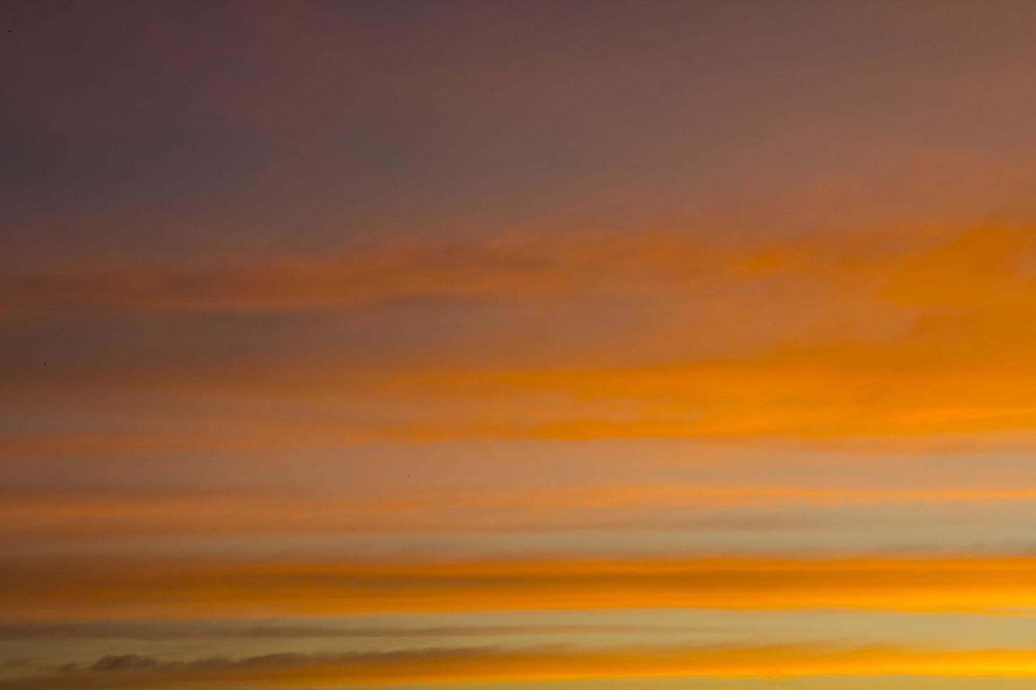 The sky is a horizontal line of yellow-orange and colorful colors in the beautiful evening in the midst of nature which is peaceful, warm and romantic in the countryside and is extremely beautiful. photo