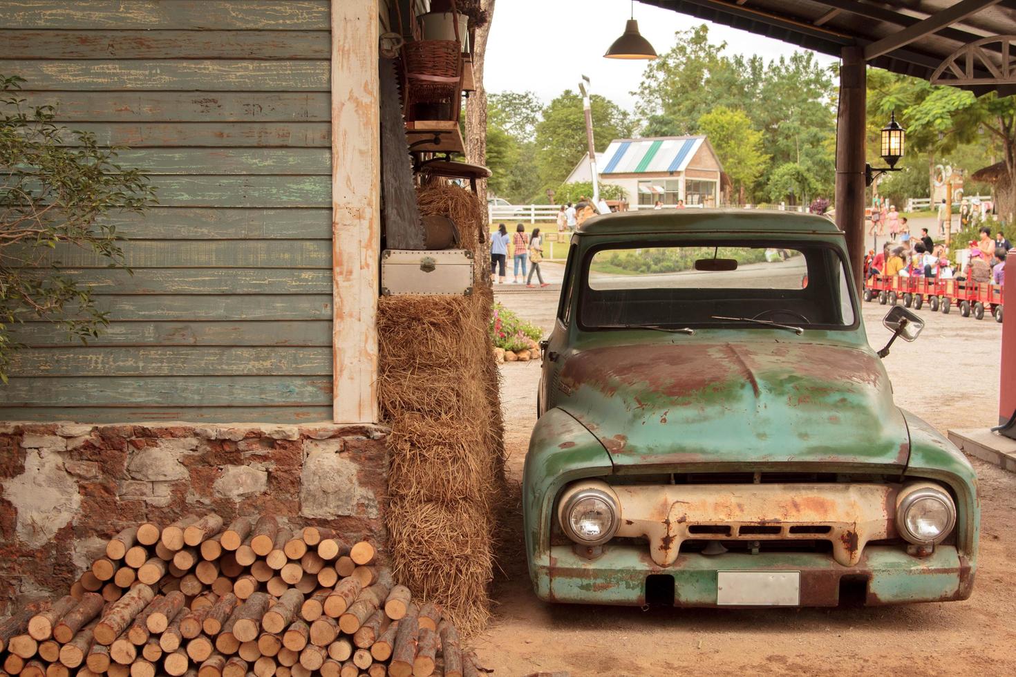 Ancient but classic car wrecks decorated in a beautiful garden in a tourist attraction that is a landmark for tourists to see-8-13-2014-Ratchaburi, Thailand photo