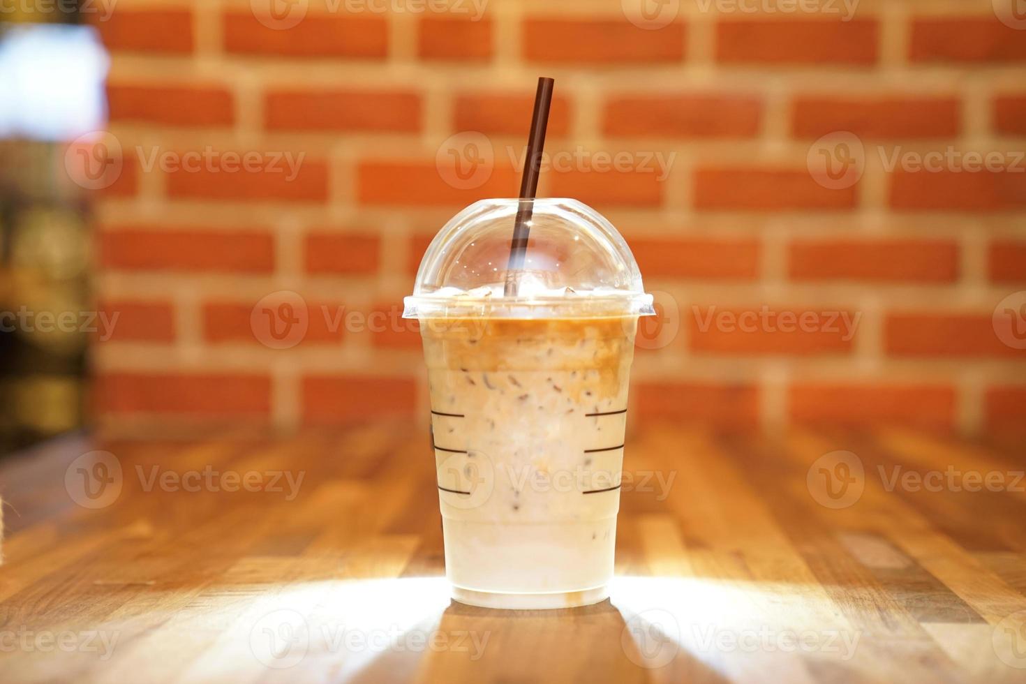 Take away Latte with Brick background on the wood table photo