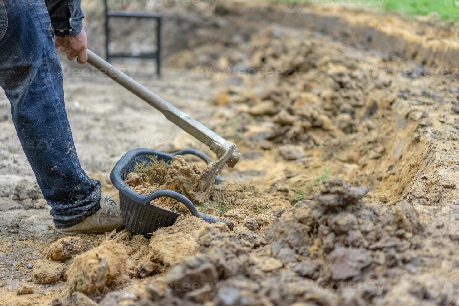 gardener digs the soil with his equipment for gardening and prepare land for plantation. photo