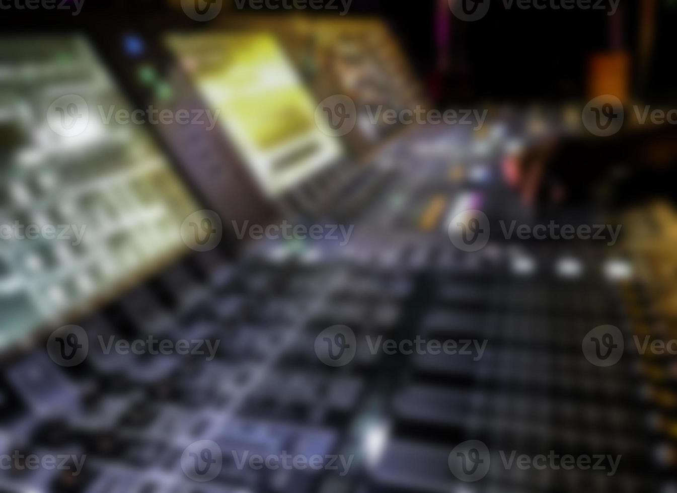 blurry Dj controles sound controller and plays mixed edm music. photo