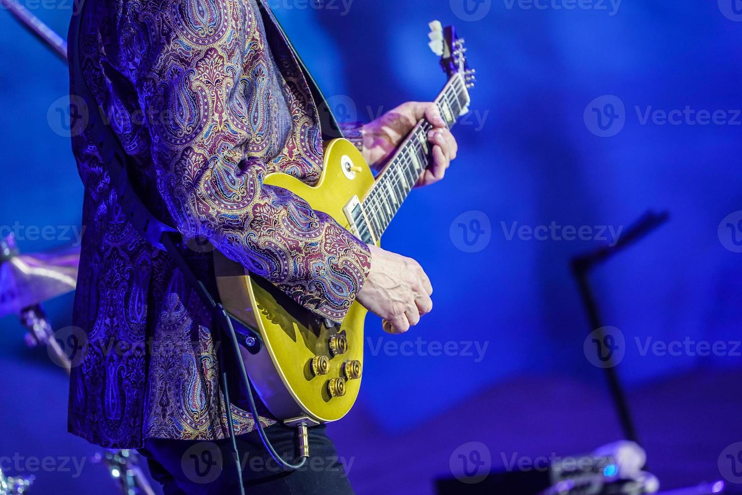 Finger style guitar, from experience expertist artist with colorful suit. photo