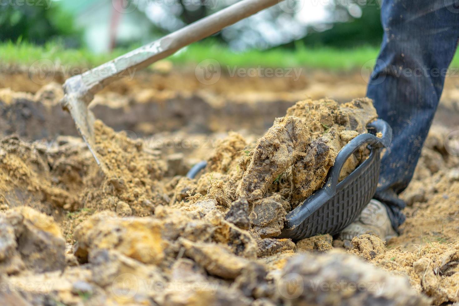 gardener digs the soil with his equipment for gardening and prepare land for plantation. photo