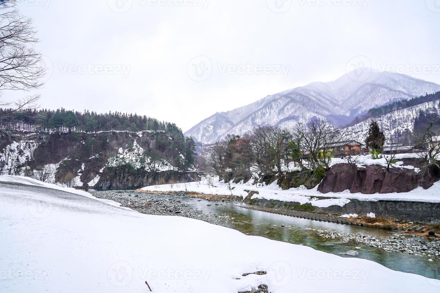 Villages of Shirakawago and Gokayama are one of Japan's UNESCO World Heritage Sites. Farm house in the village and mountain behind. photo