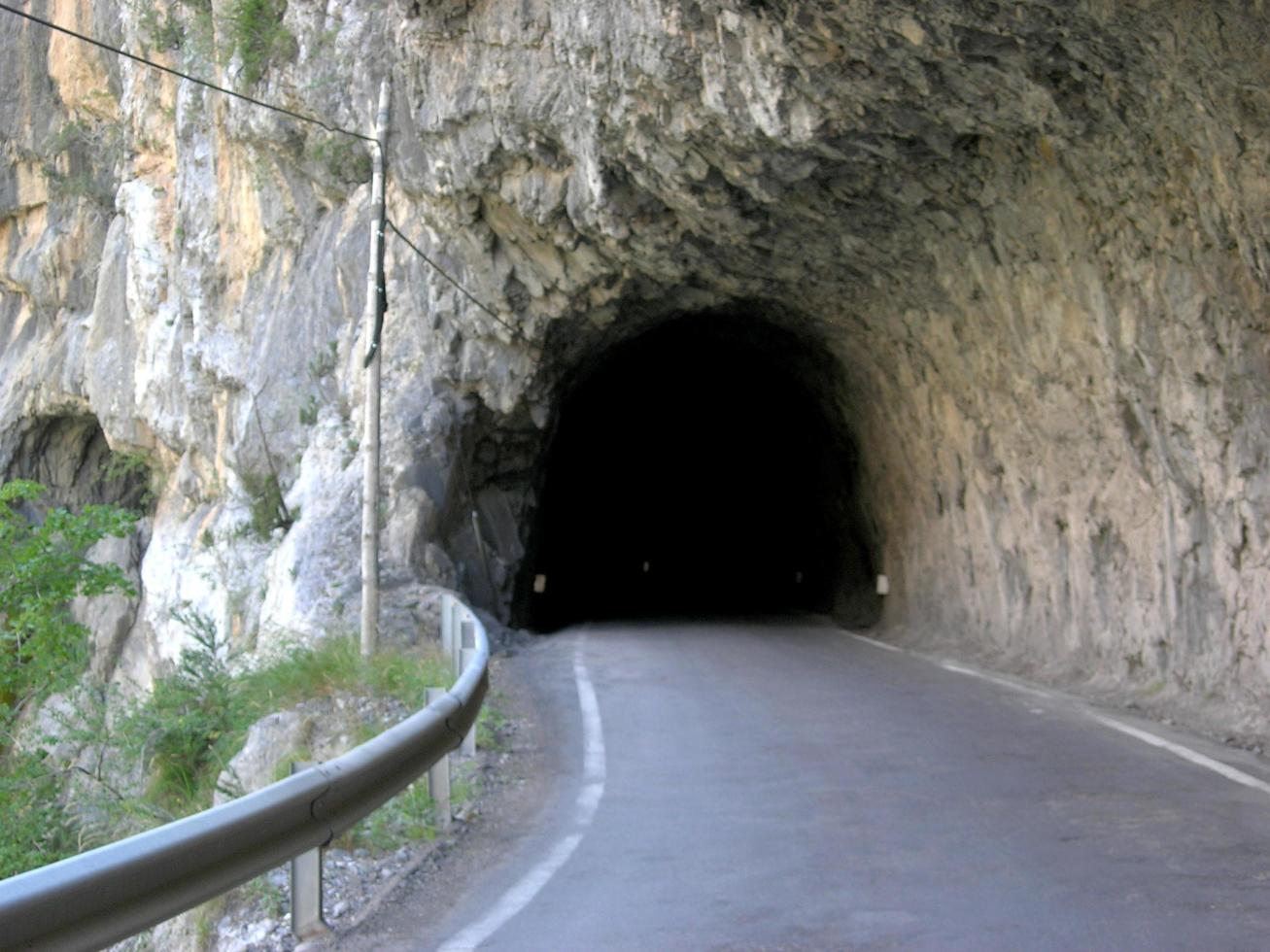 Paved road passing through a tunnel photo