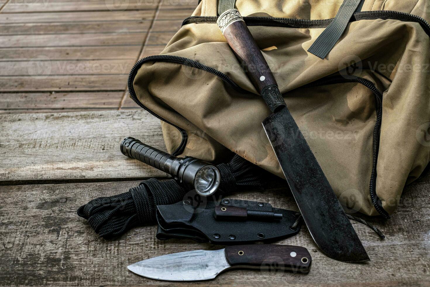 A knife with equipment for survival in the forest photo