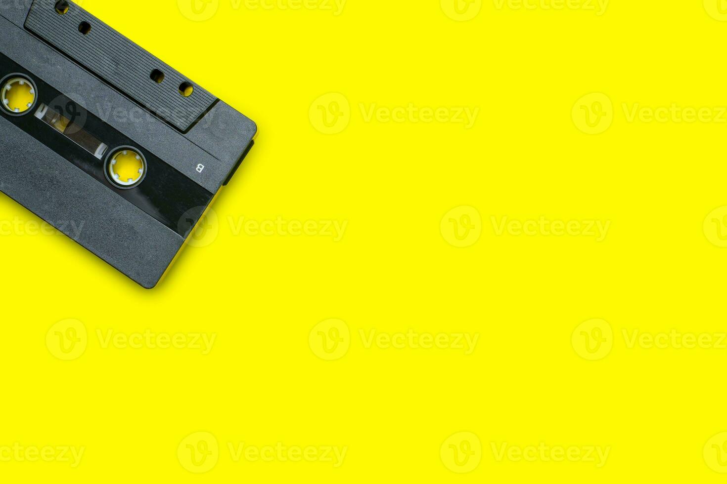 Vintage compact cassette tape on yellow background photo