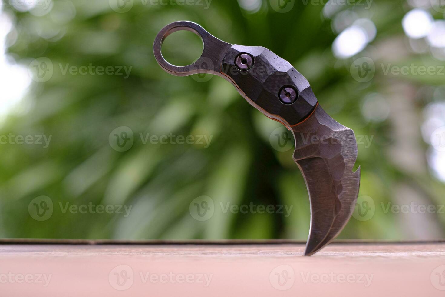 Karambit knife tactical fighter on green background photo