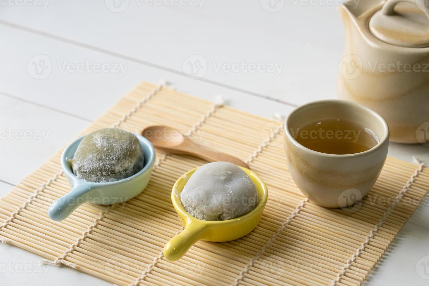 Hot Green Tea Served With Daifuku on Table in Restaurant. Japanese Food Concept photo