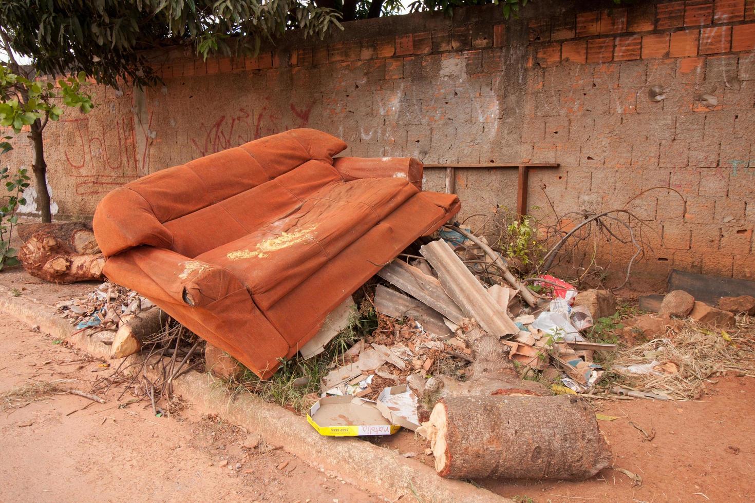 Planaltina, Goias, Brazil May 7, 2022 Trash and junk piled up on the side of the road near a house a common occurrences throughout Brazil, due to lack of garbage pick up photo