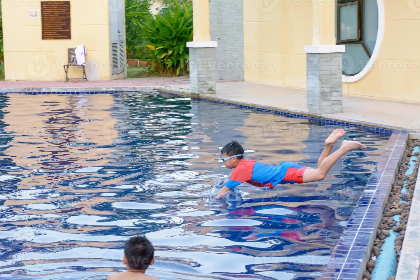 The children playing in the pool and enjoy. photo