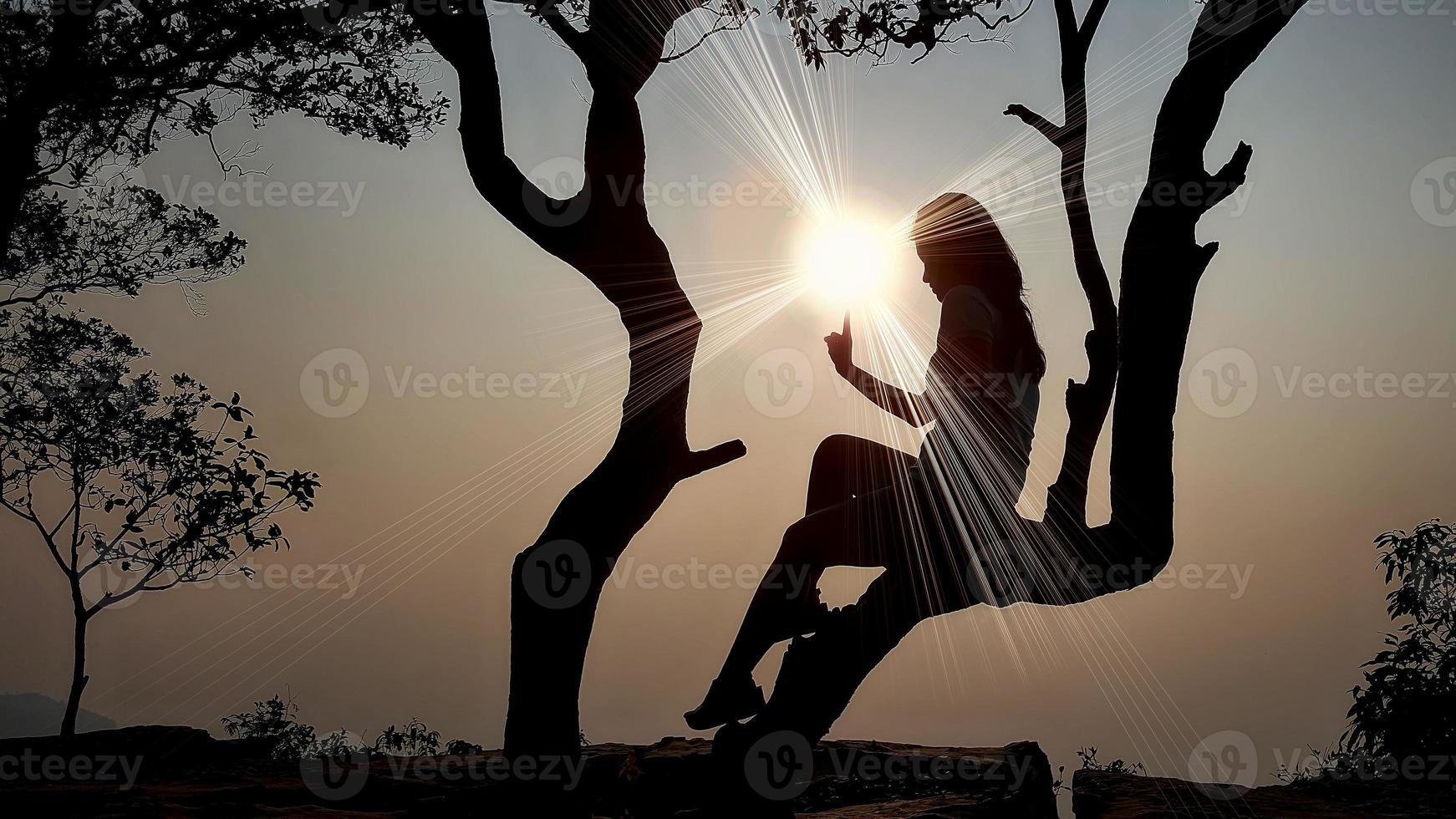 Women's silhouette at sunset on nature background. photo