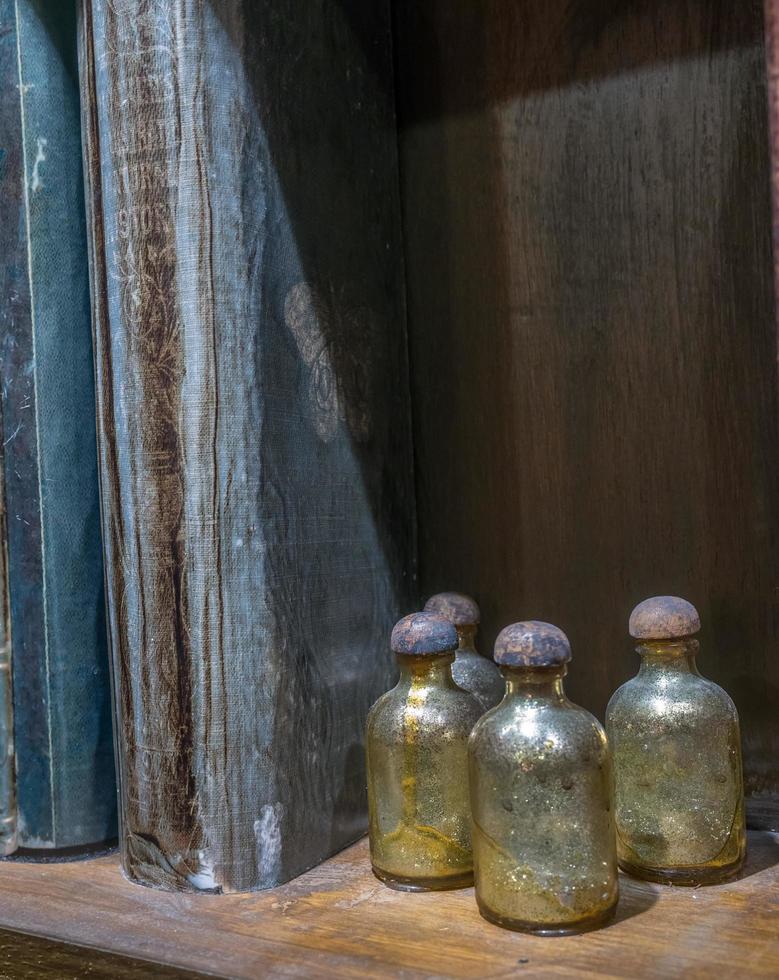Potions and books on shelf photo