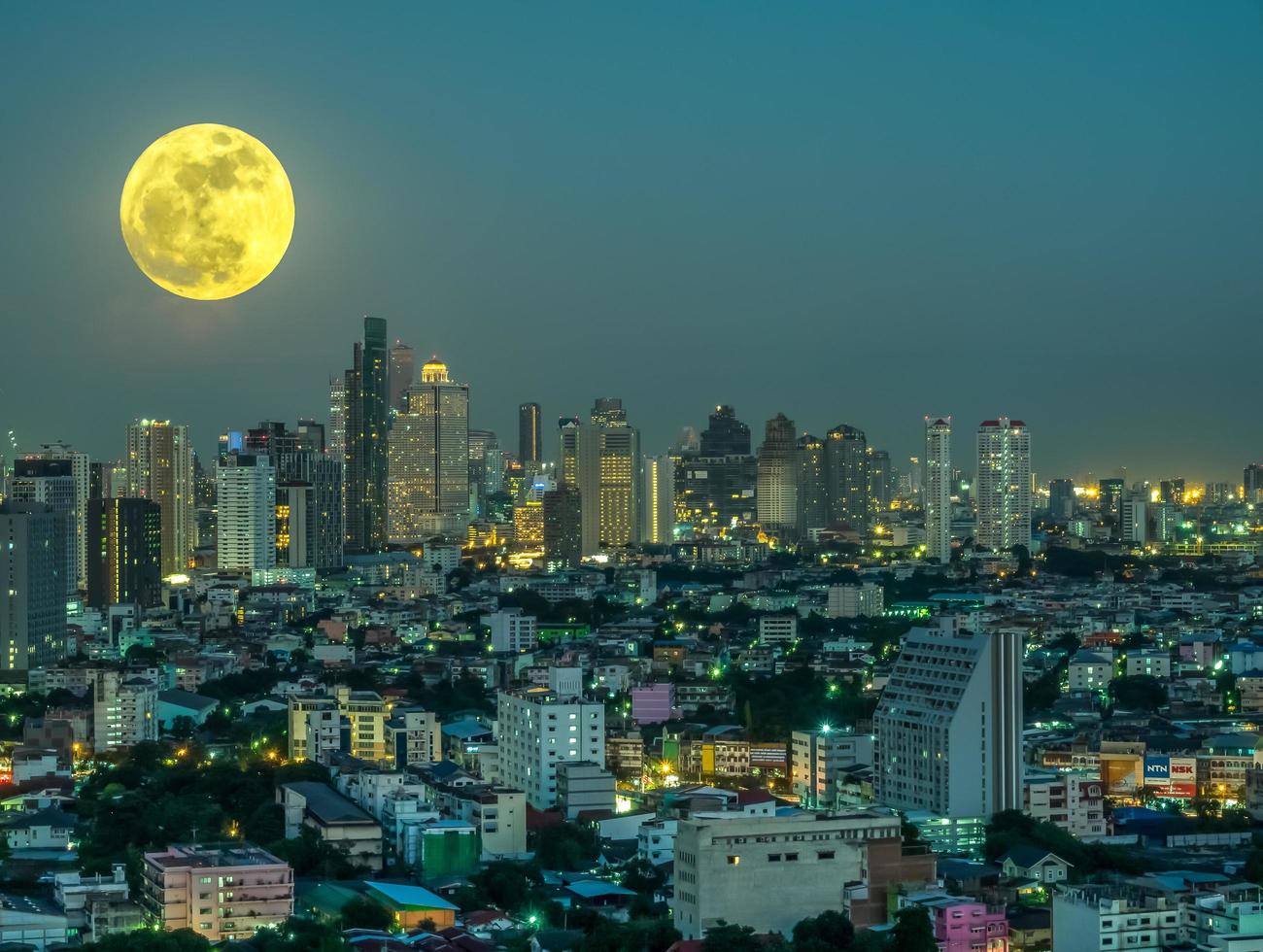 Surreal Bangkok cityscape in Thailand under full moon post production for imagination photo