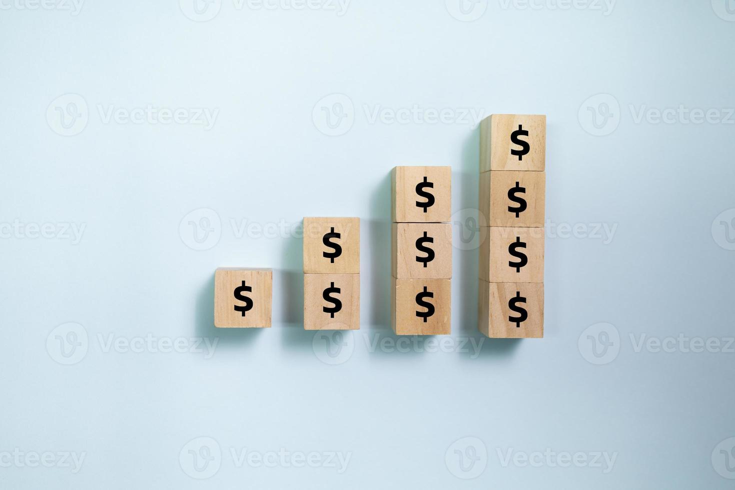 Top view wooden blocks set to growth graph with dollar money. Concept for money and success business. photo