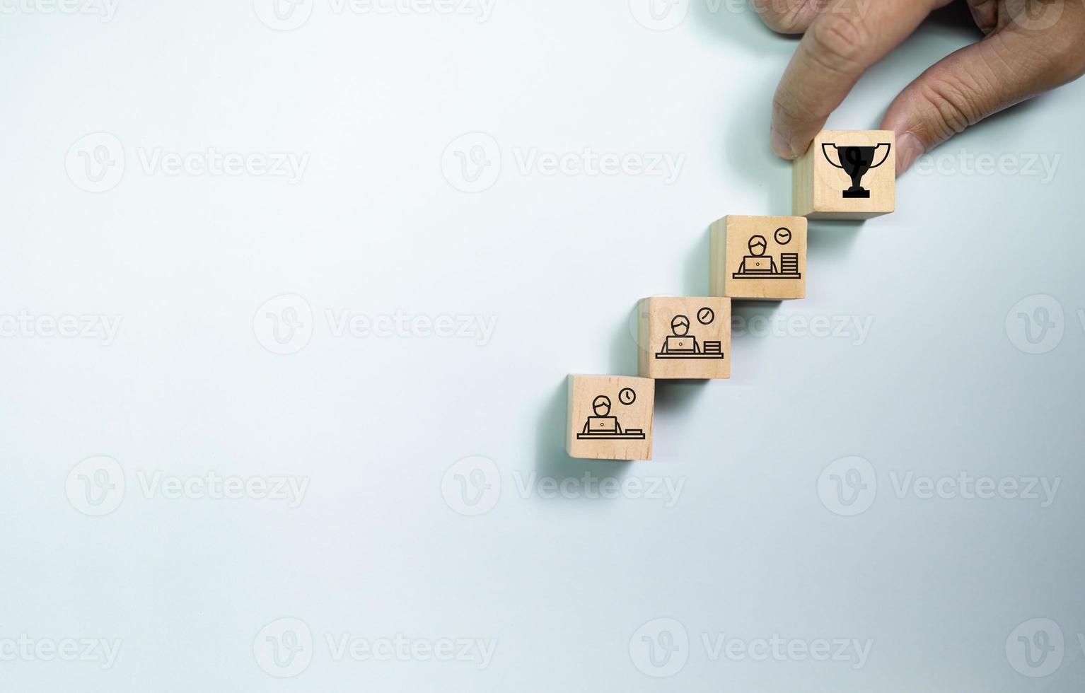 Top view wooden blocks set to step with working people to trophy. Concept for work hard and success career. photo