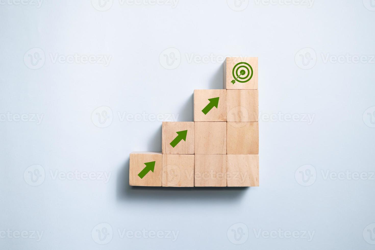 Top view wooden blocks set to step with icon arrow to target. Concept for growth business and targeting. photo