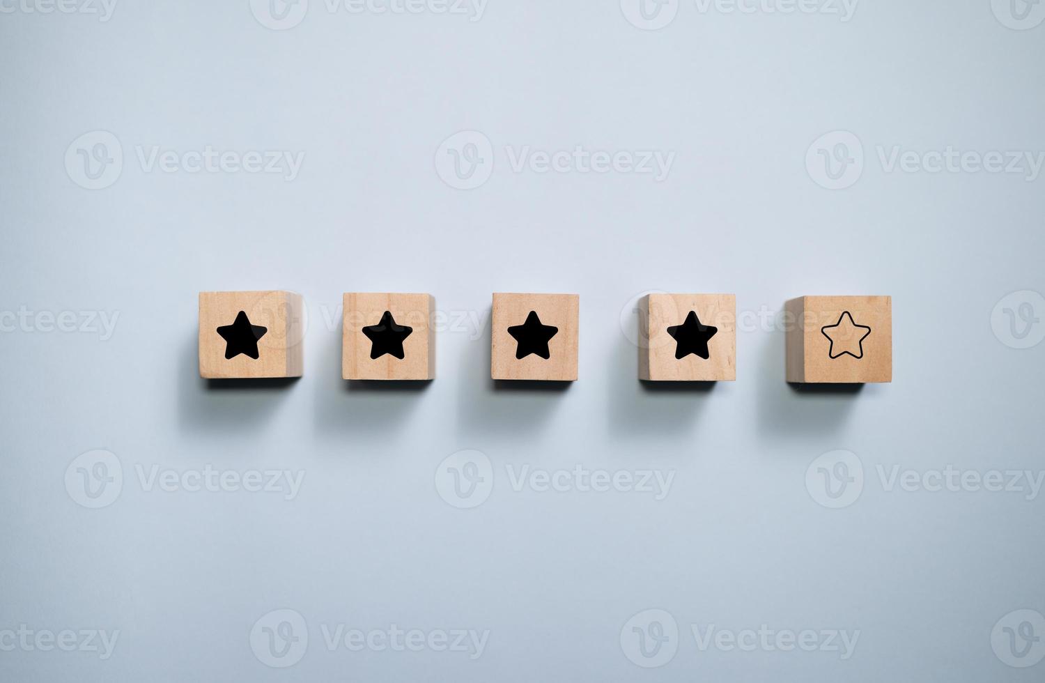 Top view wooden blocks with star rating graphic. Concept for rating and customer satisfaction. photo