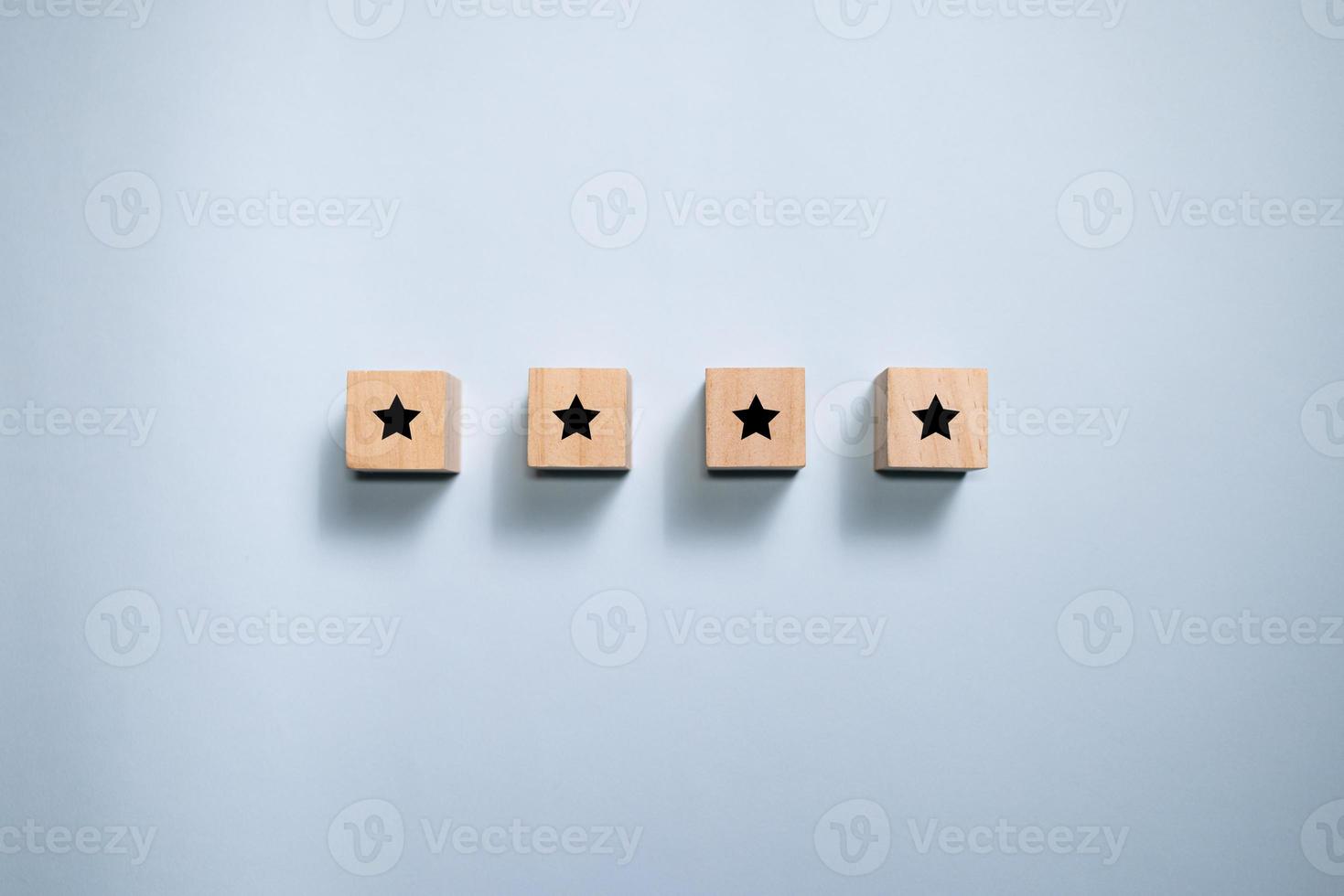 Top view wooden blocks with star rating graphic. Concept for rating and customer satisfaction. photo