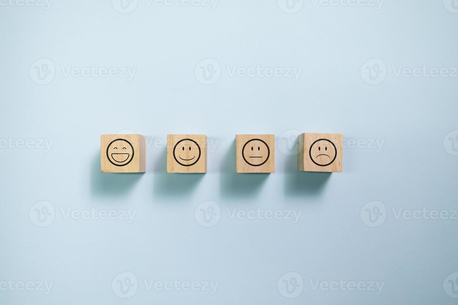 Top view wooden blocks with smiley face graphic. Concept for rating and customer satisfaction. photo