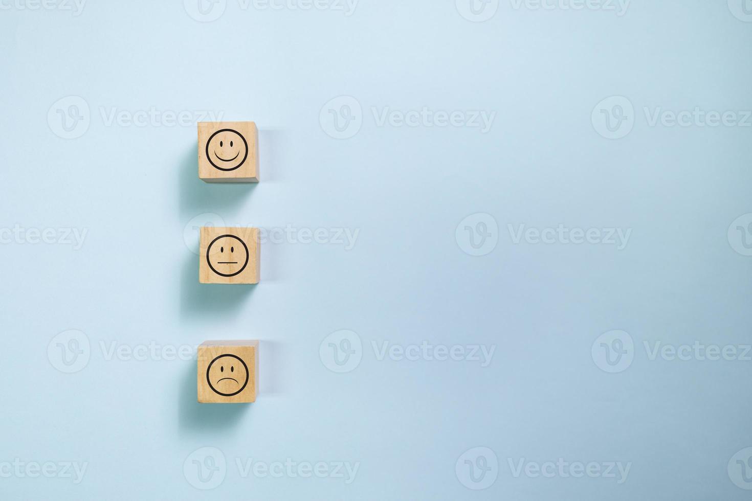 Top view wooden blocks with smiley face graphic. Concept for rating and customer satisfaction. photo