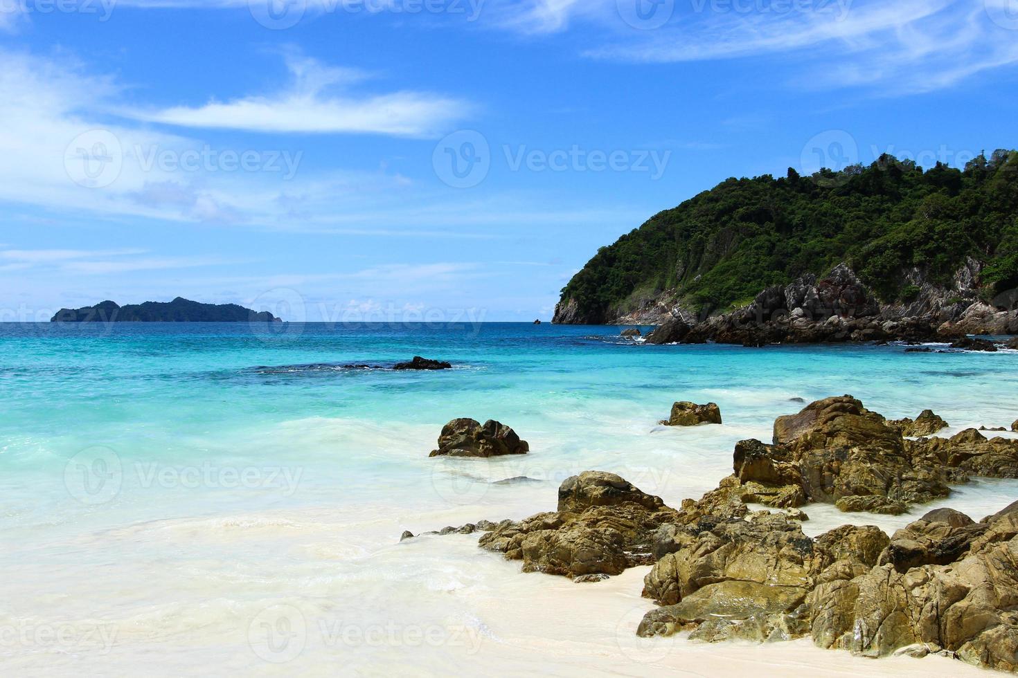 The blue sea and sky with mountain and rock photo