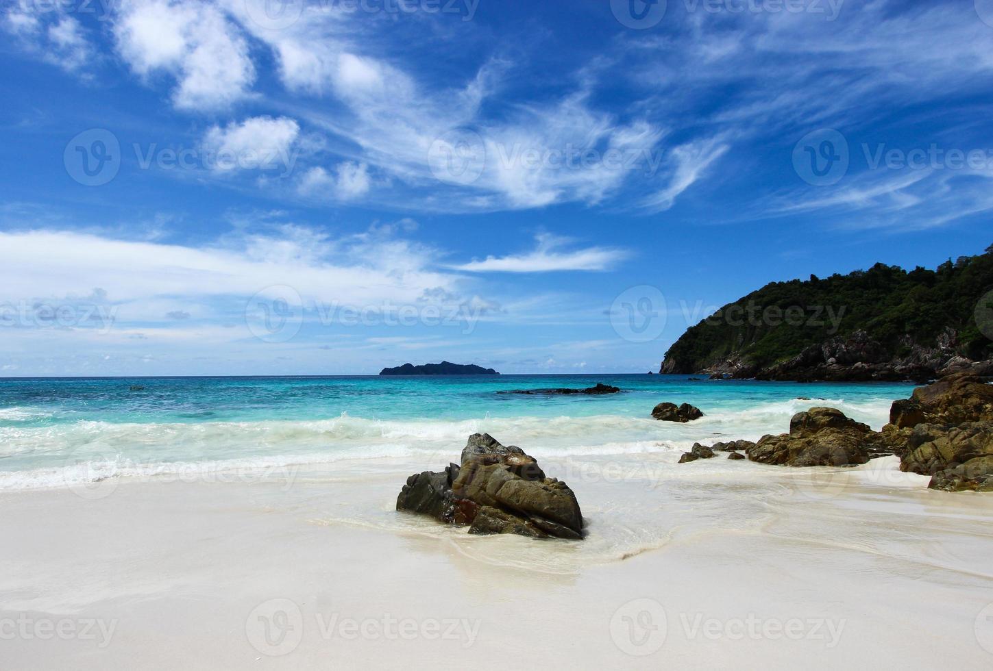 The blue sea and sky with mountain and rock photo