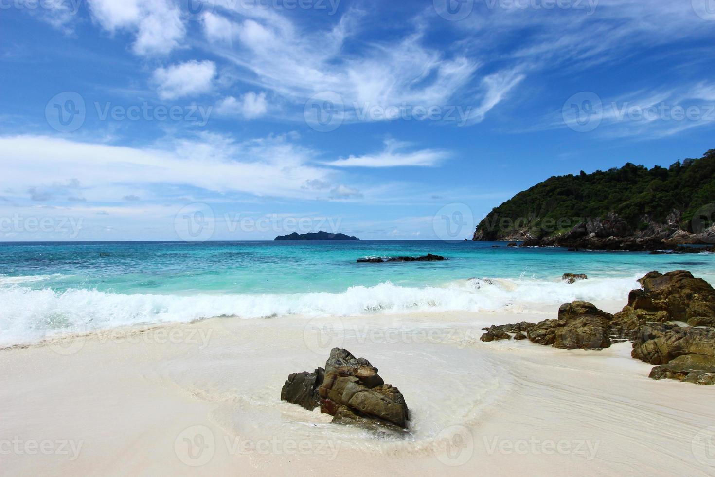 The blue sea and sky with mountain and rock photo