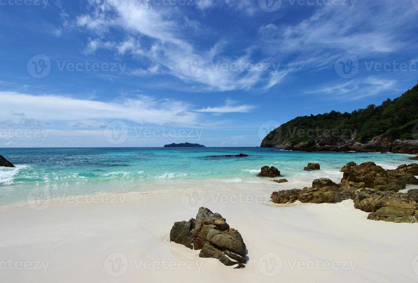 The blue sea and sky with mountain and rock photo