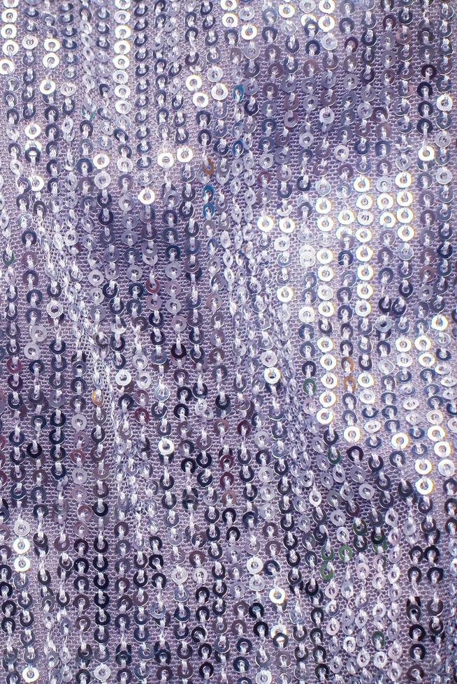 Pieces of cloth with silver sequins. Glitter background. Sequin texture photo