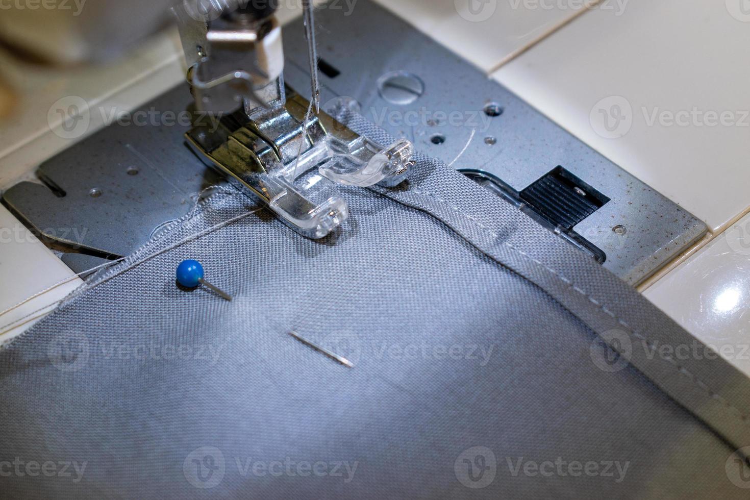 sewing a corona virus face mask at home with sewing machine photo