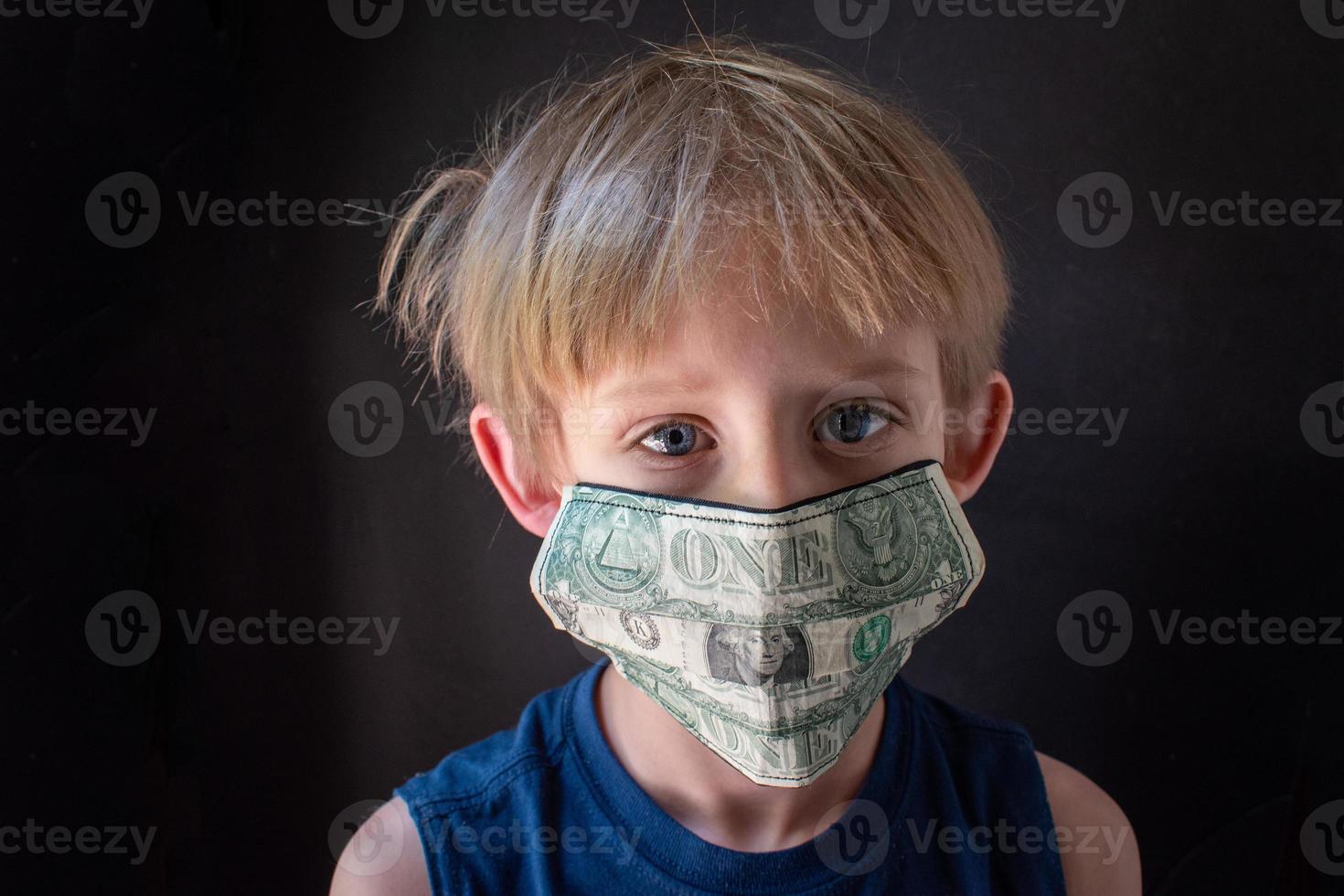 the real cost of a pandemic with medical mask made of money on face of child photo