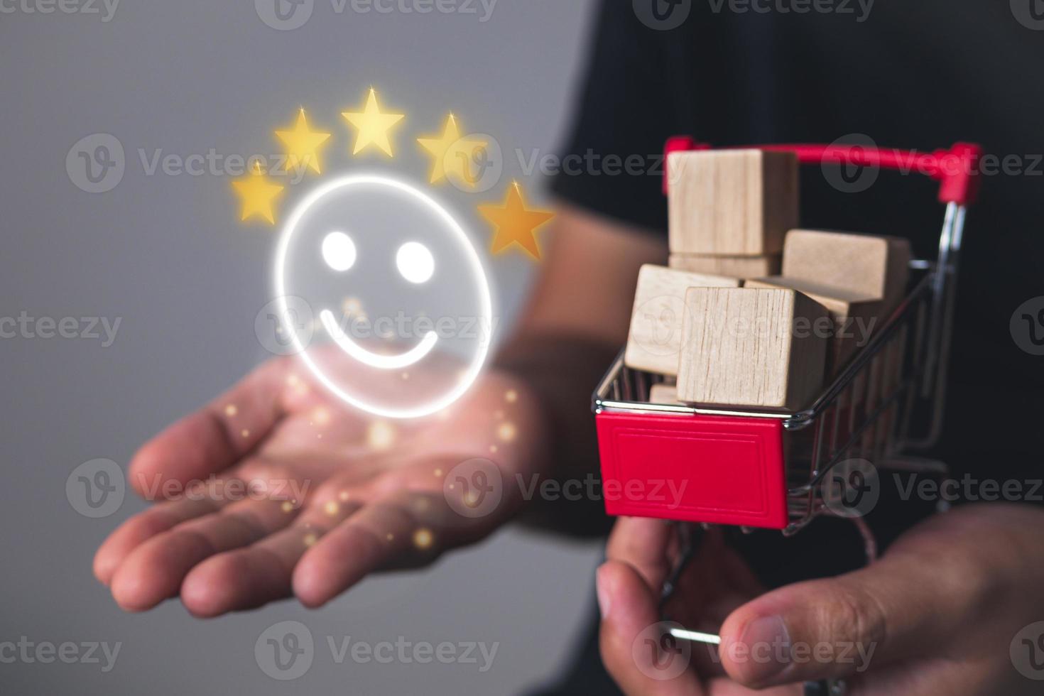 Evaluation and satisfaction concept. Five stars and smile emoji that shows an excellent supermarket. Close up shot on shopping cart. photo