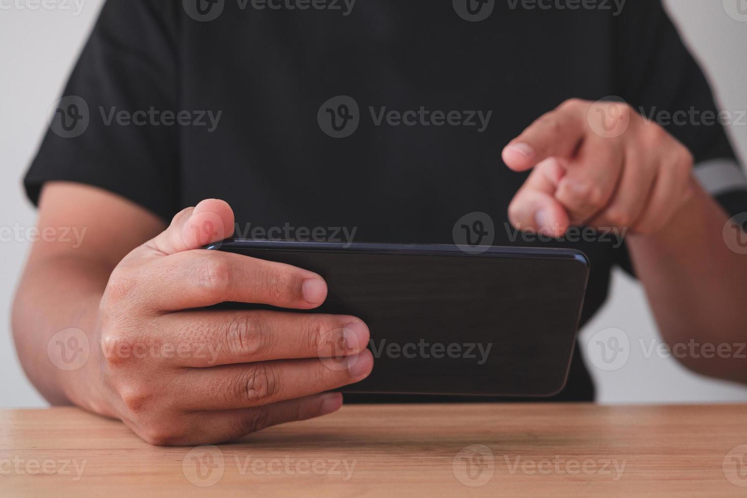 The man use a smartphone for work, social media and relaxation. Medium close up shot. photo