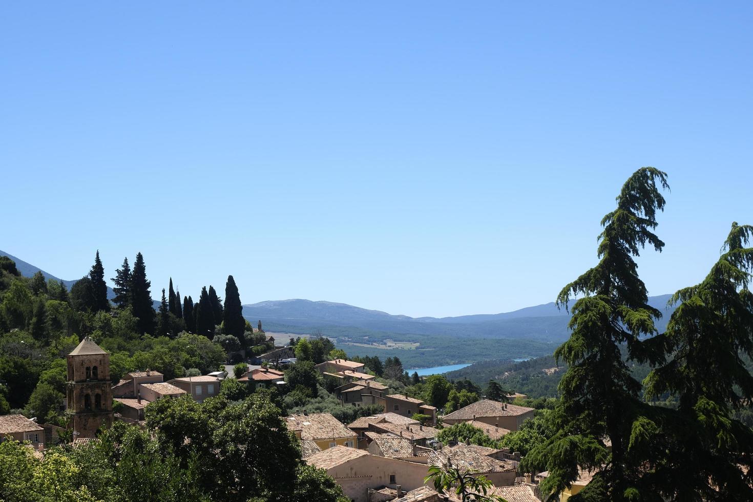 A view of an ancient rooftops of medieval village of Moustiers Sainte Marie in French Provence on a sunny summer day, beautiful natural landscape for travel design, vacation destination photo