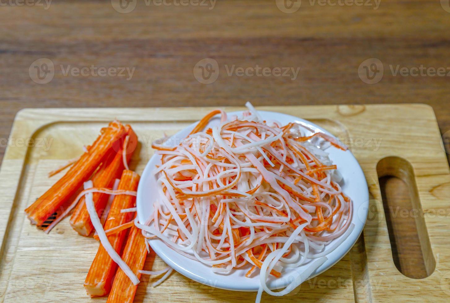 Japanese food crab sticks on wooden cutting board. photo