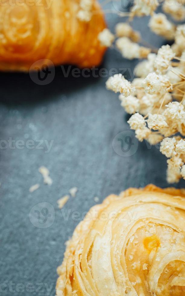 Curry puff pastry in a stone plate placed on a wooden table. photo
